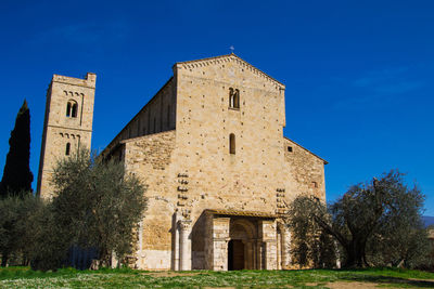 Low angle view of historic building against clear blue sky