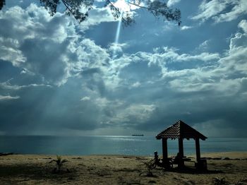 Lifeguard hut on beach against sky