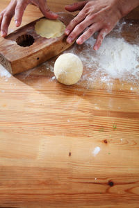 Close-up of woman preparing food on cutting board