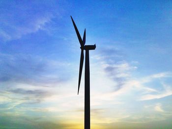 Low angle view of silhouette windmill against sky