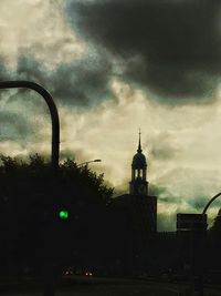 Low angle view of building against cloudy sky