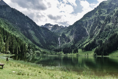 Scenic view of lake and mountains against sky