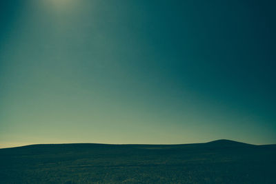 Scenic view of landscape against clear blue sky