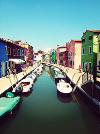 Boats in canal with buildings in background