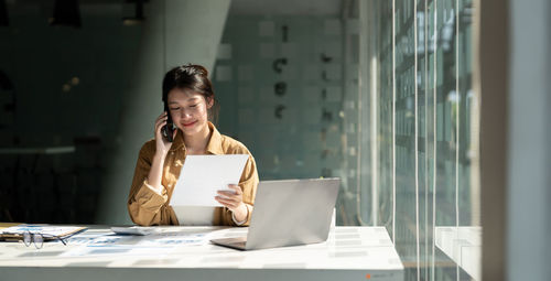 Businesswoman using laptop at office