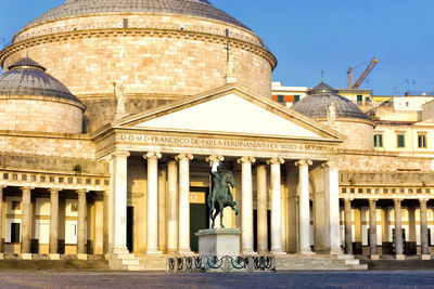 Statue in front of historical building