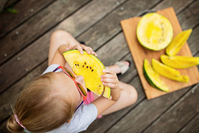 High angle view of girl holding fruit