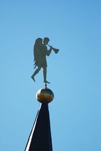 Low angle view of statue against clear blue sky