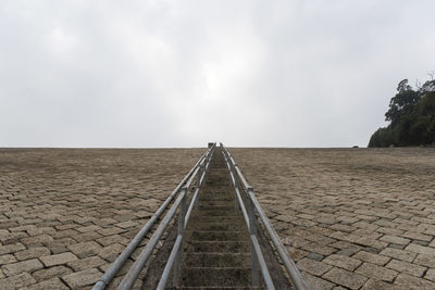 Scenic view of footpath against sky