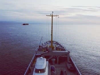 Sailboat in sea against sky