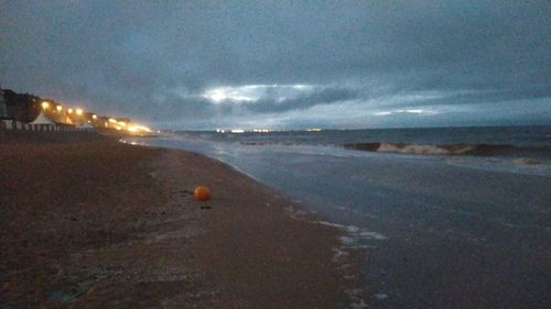 Scenic view of beach against sky at night