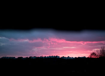 Silhouette landscape against sky during sunset