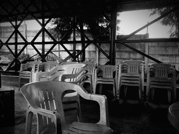 Empty chairs and table against sky