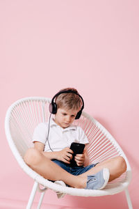 Full length of boy using mobile phone