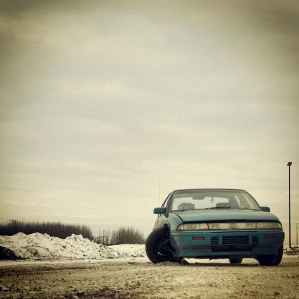 transportation, land vehicle, mode of transport, car, snow, winter, sky, cold temperature, weather, road, landscape, cloud - sky, street, field, season, nature, travel, outdoors, no people, day