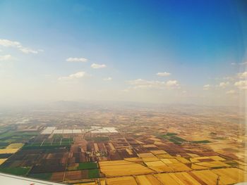 Aerial view of agricultural field against sky