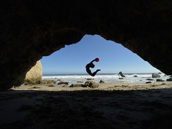 Man on beach against sky