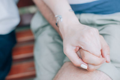 Close-up of couple holding hands