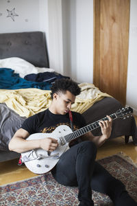 Young man playing an electric guitar