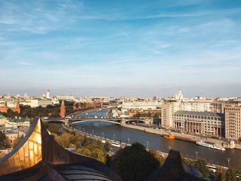 Bridge over river against buildings in city