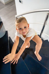 High angle view of young woman standing in gym