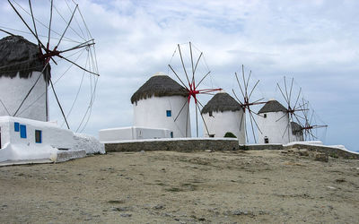 Low angle view of traditional windmill on beach against sky