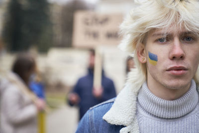 Portrait of man with face paint during protest