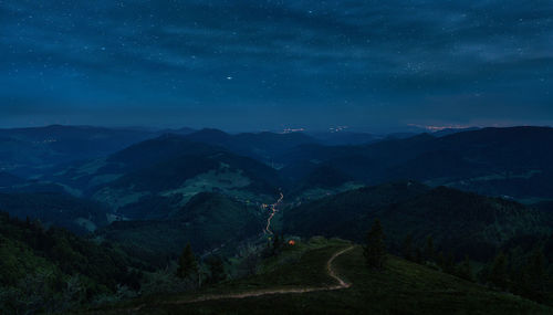 Scenic view of mountains against sky at night