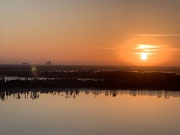 Scenic view of lake against sky during sunset