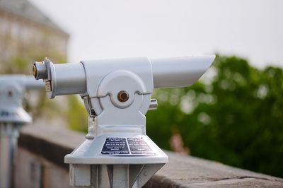 Close-up of coin-operated binoculars against sky