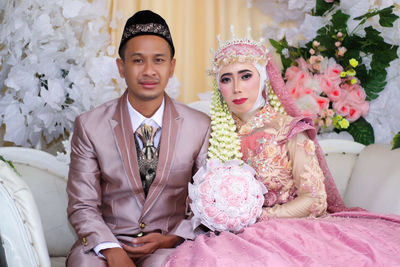 Portrait of young couple during wedding ceremony