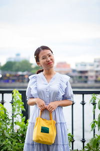 Portrait of a smiling young woman standing outdoors