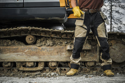 Low section of man standing on railroad track