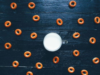 High angle view of milk by cookies on table