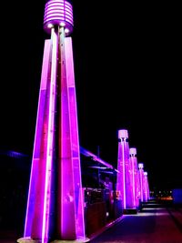 Low angle view of illuminated building against sky at night