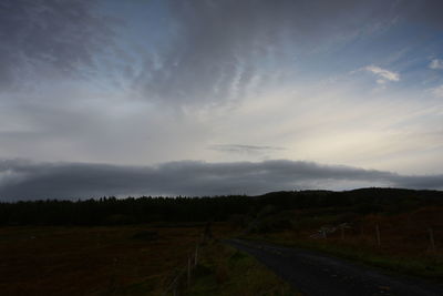 Road by landscape against sky