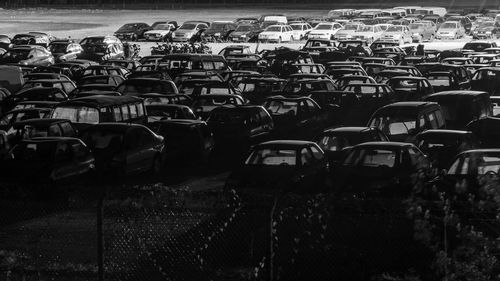 Courtyard of crashed cars at night.