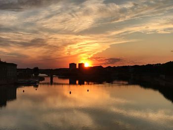 Scenic view of lake against orange sky