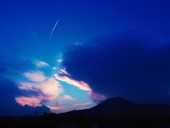 Scenic view of mountains against cloudy sky