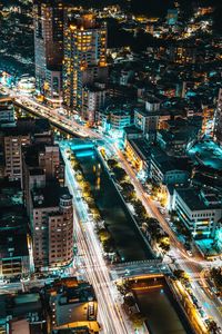 High angle view of city lit up at night