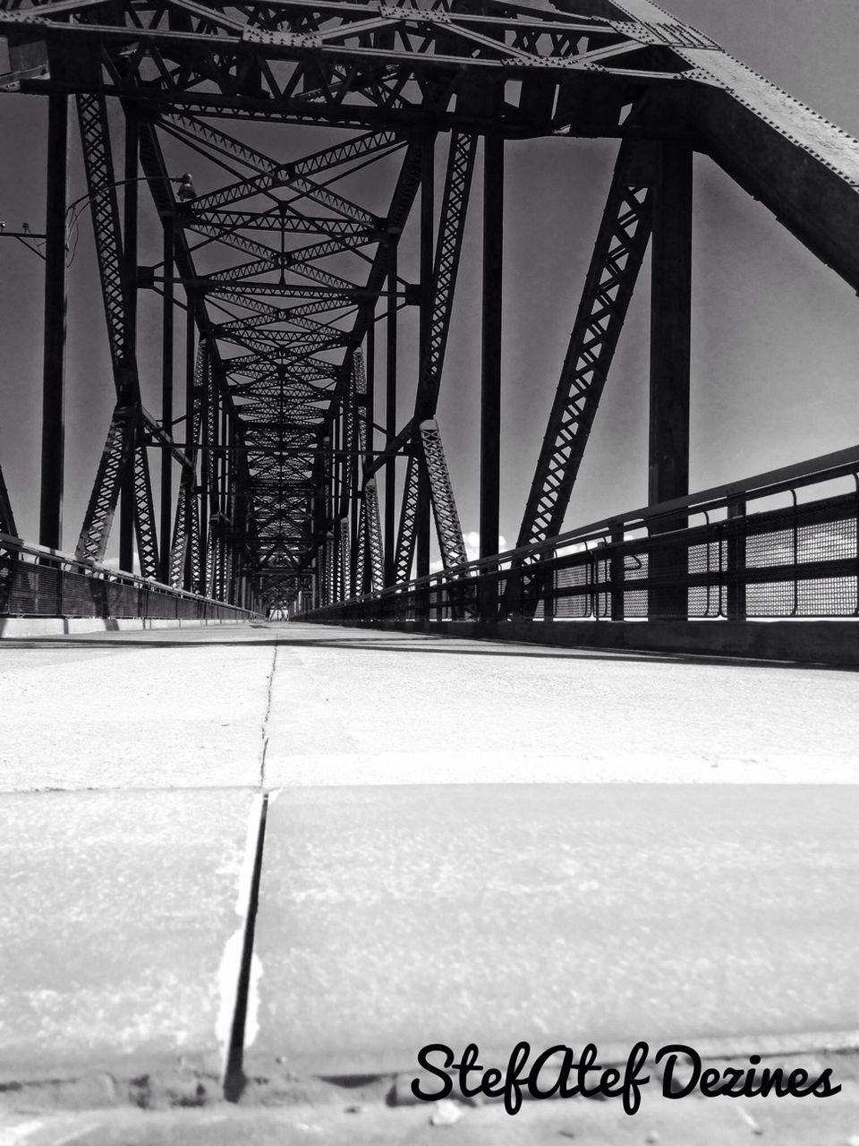 connection, bridge - man made structure, engineering, built structure, transportation, architecture, suspension bridge, bridge, metal, river, long, golden gate bridge, low angle view, clear sky, metallic, travel destinations, water, railing, the way forward, sky