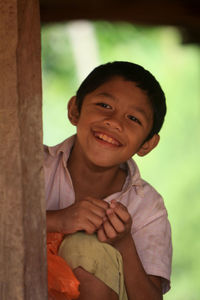 Close-up of smiling boy looking away