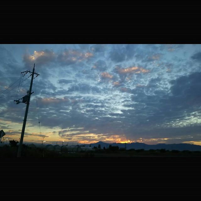 sky, sunset, cloud - sky, silhouette, transportation, cloudy, cloud, scenics, window, nature, transparent, beauty in nature, tranquility, dusk, glass - material, tranquil scene, car, vehicle interior, electricity pylon, no people