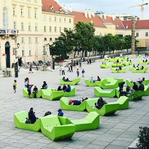 People in park against sky in city