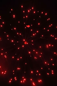 Low angle view of firework display against sky at night