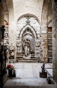 Statue against historic building