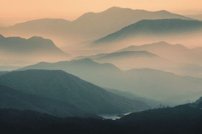 Scenic view of silhouette mountains against sky during sunset