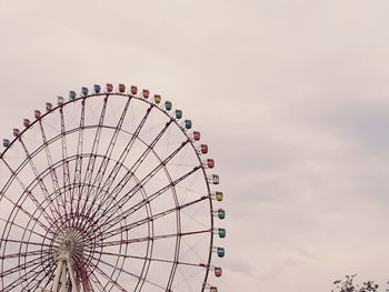 Low angle view of ferris wheel against sky