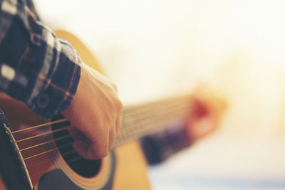 Close-up of man playing guitar