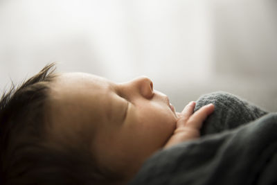 Side profile view of sleeping newborn with lots of hair